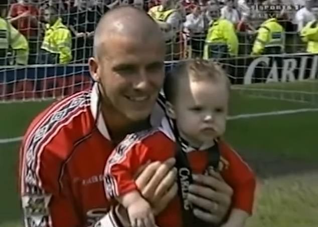 Years later as an established footballing icon, David held his young son on the day Man United won the league